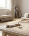 Spritz Wellness luxury incense on a ceramic holder