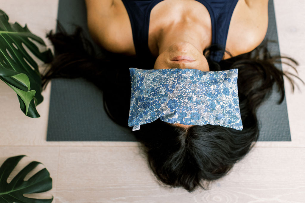 Savasana rest pose with a Spritz Wellness eye pillow