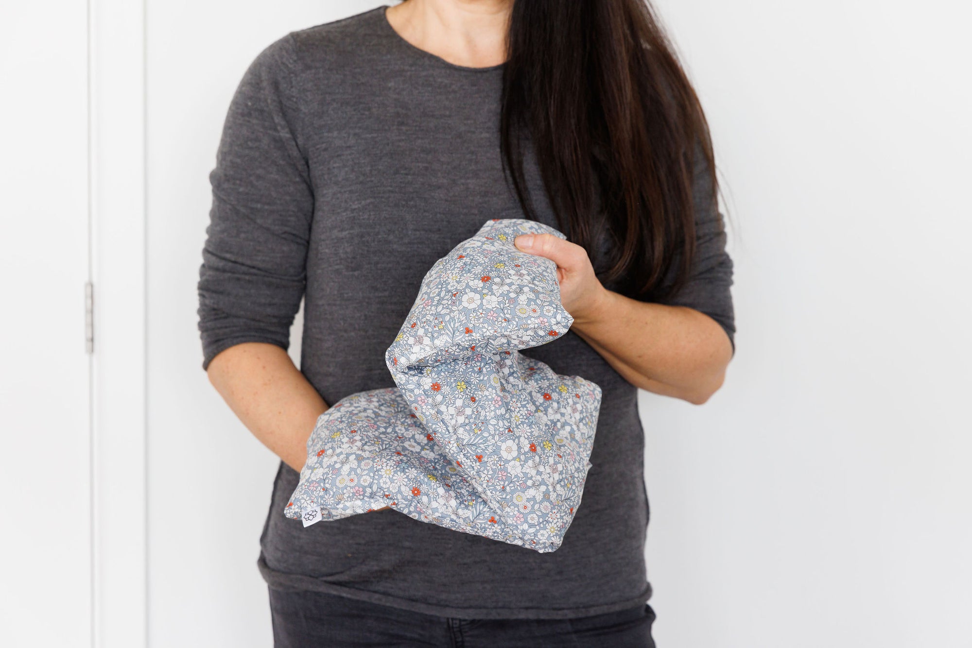 Aromatherapy wheat bag with a grey flowers Liberty Print design, made by Spritz Wellness, London.