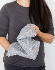 Aromatherapy wheat bag with a grey flowers Liberty Print design, made by Spritz Wellness, London.