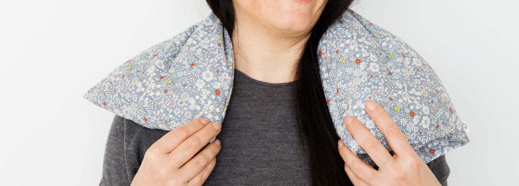 Aromatherapy wheat bag with a grey flowers Liberty Print design, made by Spritz Wellness, London.