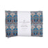A packaged aromatherapy wheat bag with a blue geometric pattern and the brand 'Spritz Wellness' visible on the label.